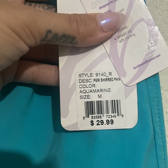 Teal scrubs with five pockets. One is a zip pocket. - Picture 4 of 4